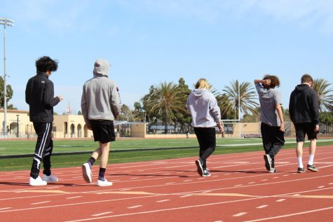 P.E. students walking the track.