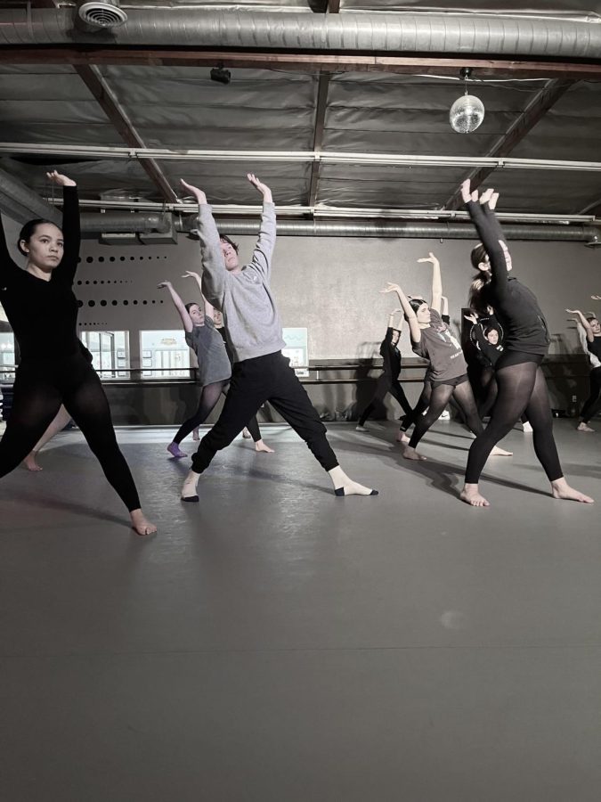 A photo of dancers in the midst of a rehearsal.