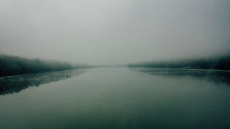 Serene river between trees under foggy sky fair use via Pexels. 
