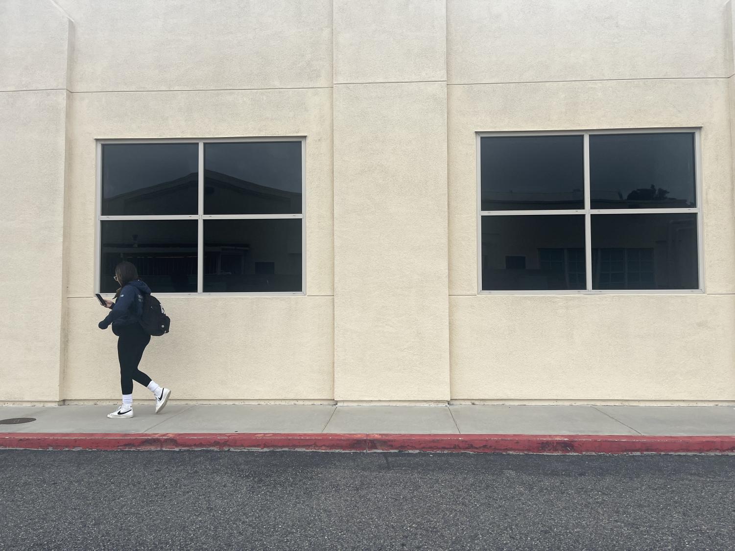 Sophia Romo walking through Huntington Beach High Schools campus. (Photography by: Natalie Meschuk)