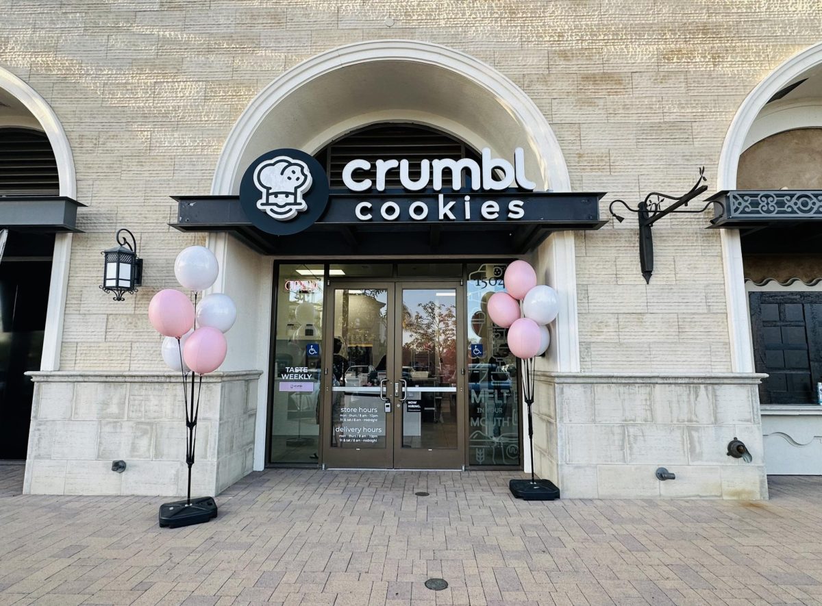 The outside view of Crumbl Cookies, located beneath the Bella Terra Residence.