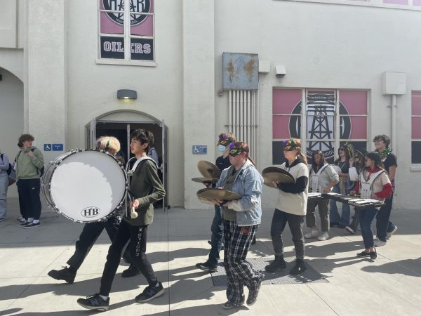 A photo of APA and band performing in the Mardi Gras Parade at Huntington Beach High School.