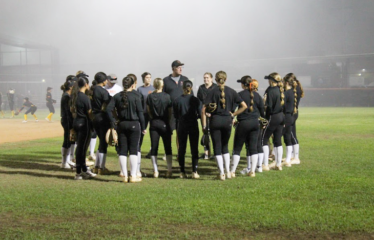 HBHS softball team huddle before game. 