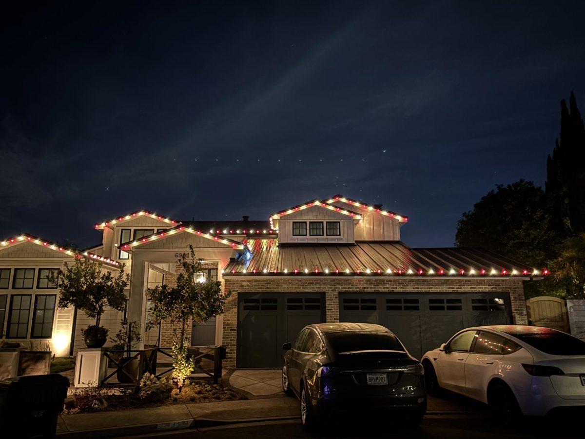 A house festively decorated with red and white lights to welcome Christmastime.