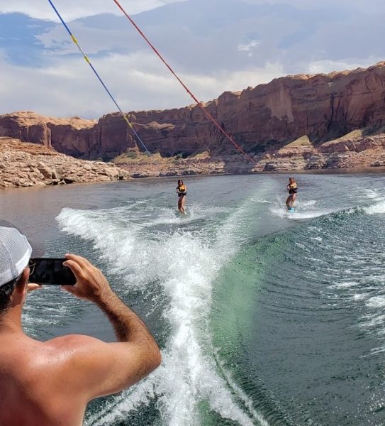 An image of people wake boarding on a sunny day at Lake Powell.