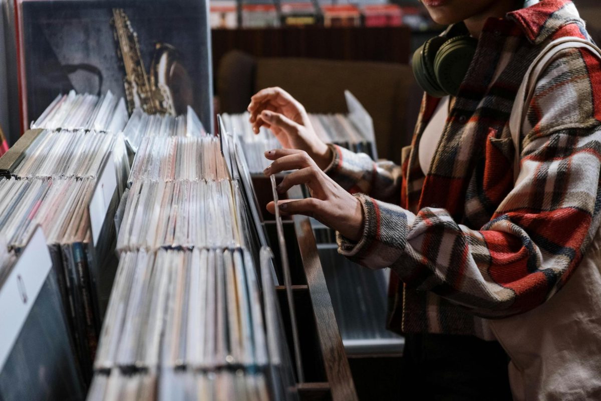 Person looking through albums at a record shop. Photo by Cottonbro Studio from Pexels. 