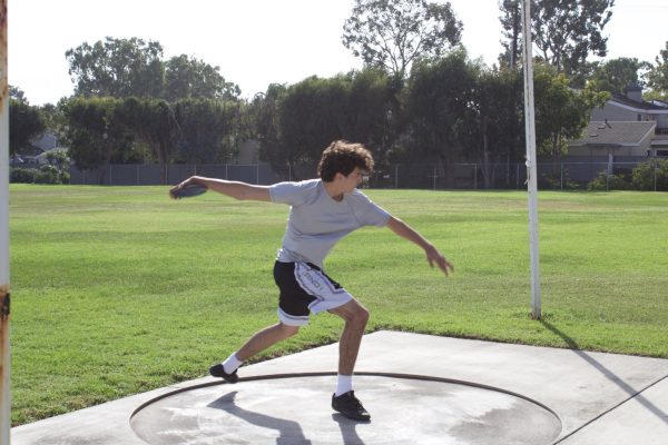 Senior thrower JR Navarro about to throw a disc during practice.