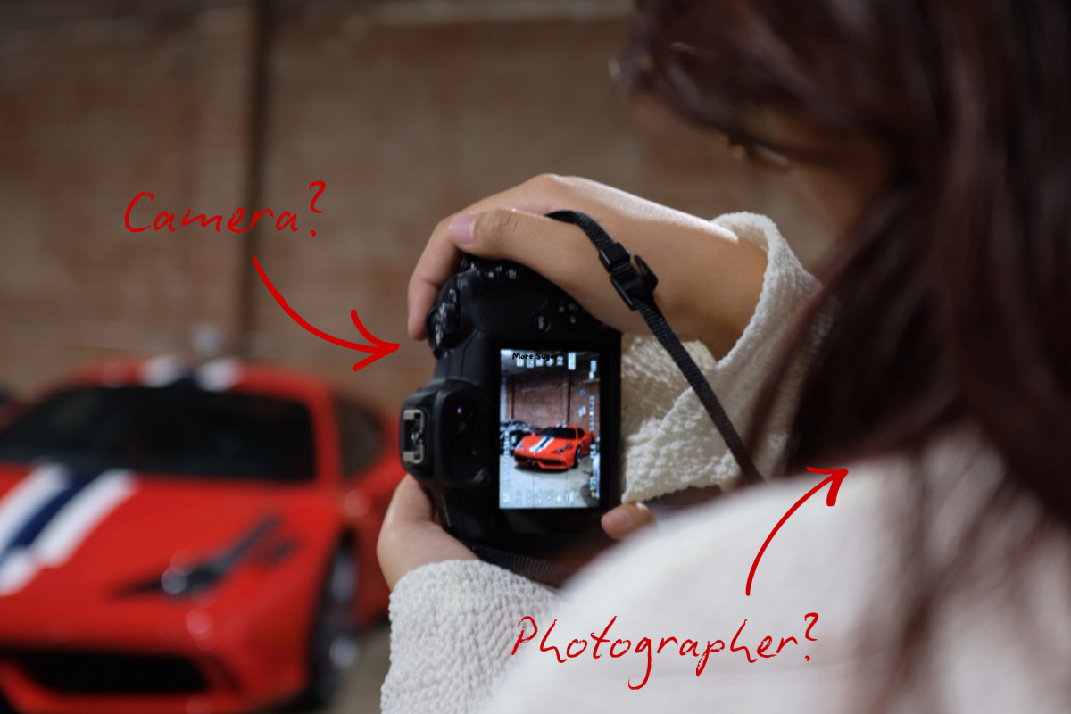 A photographer taking an image of a car, shot on a 2023 Samsung Galaxy S23 Ultra, a mobile phone.