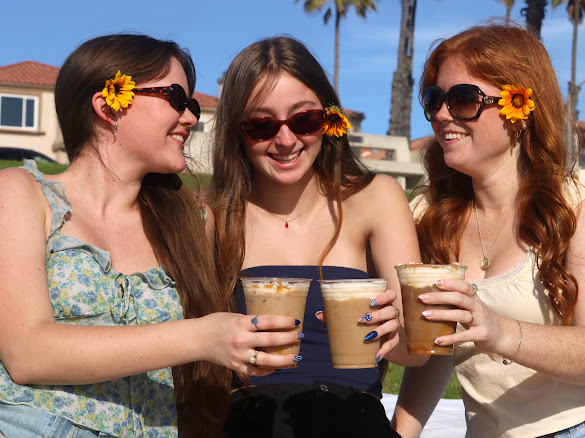 The founders of Salty Sun HB, Izzy Vosper, Sami Scot and Taylor Spence (from left to right) enjoy their coffee in the warm sun.