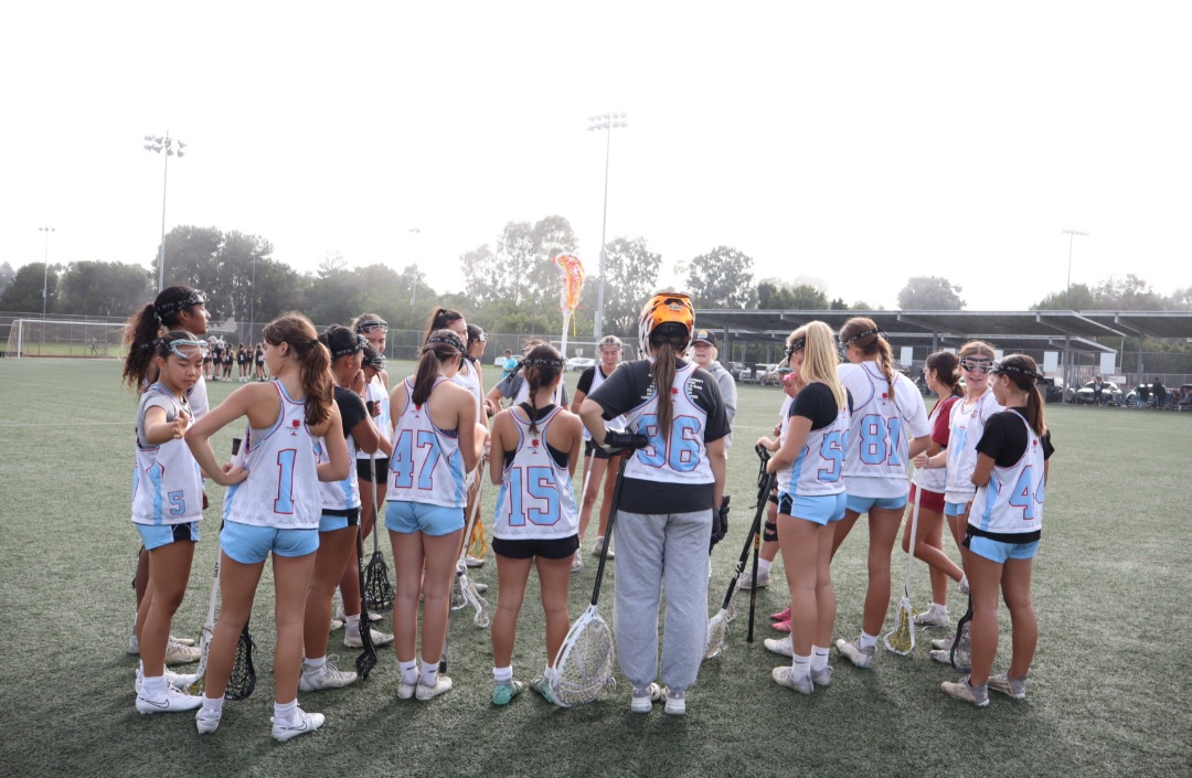 The Huntington Beach High School Girl's Lacrosse Team huddles before practice.